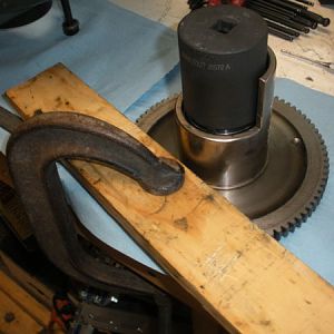 You'll have to hold the bull gear in a way that allows you to tighten the lock nut. I clamped down with a c-clamp and a chunk of wood to the bench.