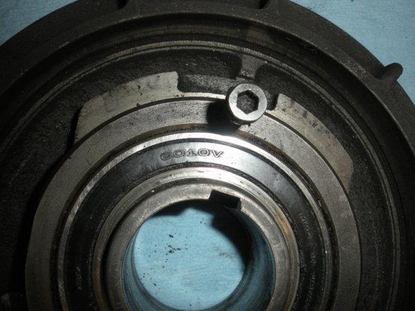Close up of old bearing in brake bearing cap.  I used two pry bars under the edges of this cap and it came right off with the bearing. Easy.