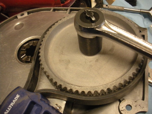Hold the timing gear with a strap wrench while you tighten the nut.