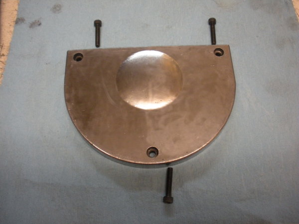 Motor pulley access plate with socket head screws.