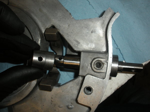Slide the brake operating came over the end of the brake lever shaft.. then slide the brake lever shaft the rest of the way in place.