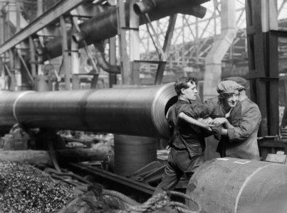 Q-30134-A-munitions-worker-is-lifted-into-the-barrel-of-a-15-inch-naval-gun-manufactured-at-the-.jpg