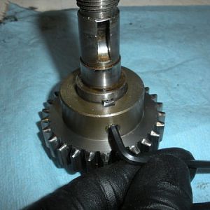 The pinion gear is fixed in place by a set screw.