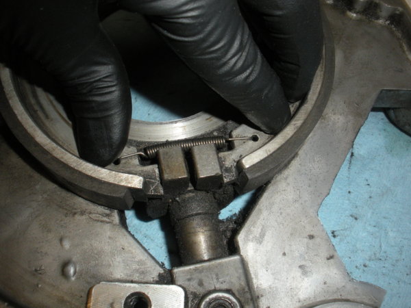 After you've removed the screw in the picture before this the brake shoes will lift right out... The cam fingers are holding the shoes apart here.