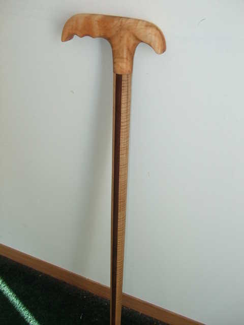 Cane made for my late Father. I embellished it with insignia's of his military record. Made with Maple and Walnut.