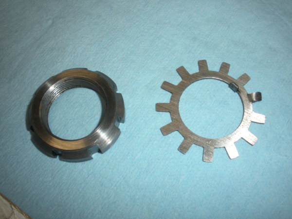 Lock nut and lock washer that come off first.