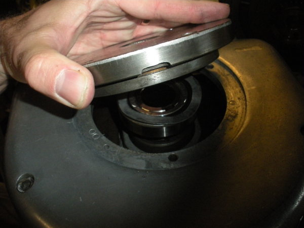 Place the bearing cap over the bearing and the wavy spring washer.