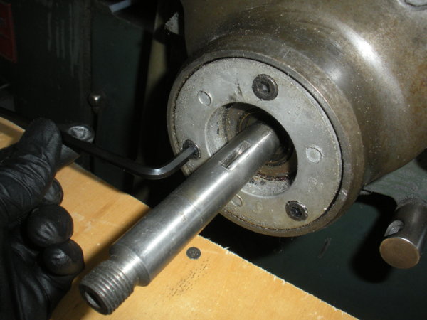 Remove the three cap screws holding the bearing retainer.
