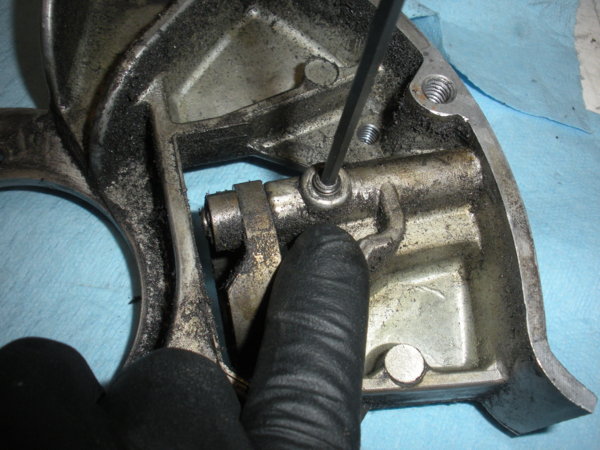 Remove this set screw on the bottom side of the housing. This screw holds the brake operating finger pivot stud.