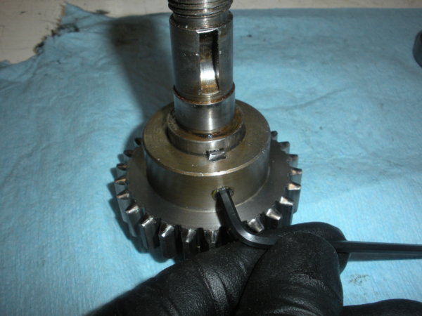 The pinion gear is fixed in place by a set screw.
