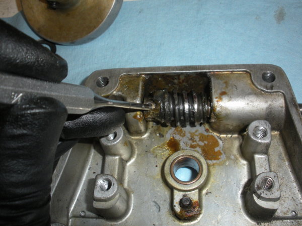 Use a punch to remove the pin. This will allow you to remove the shaft...but don't unless you have to!